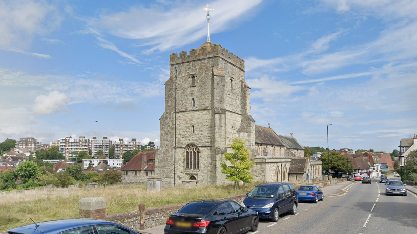 A grey church on a sunny day.