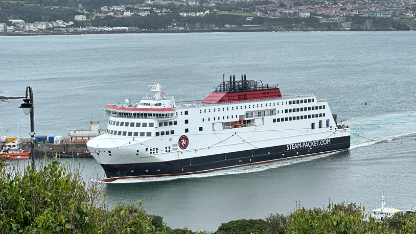 The Manxman ferry, which is decorated in the Isle of Man Steam Packet red, black and white livery, sailing into Douglas Harbour.