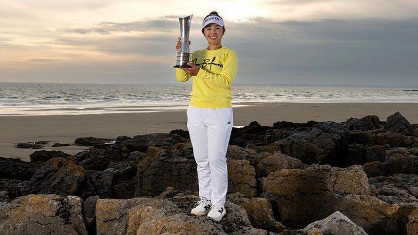 Miyu Yamashita holds her trophy at the Porthcawl coastline 