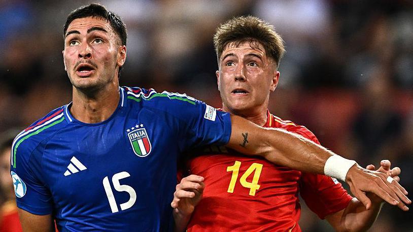 Diego Coppola (left) holds off Spain's Mikel Jaureguiza at the Uefa Under-21 Championship