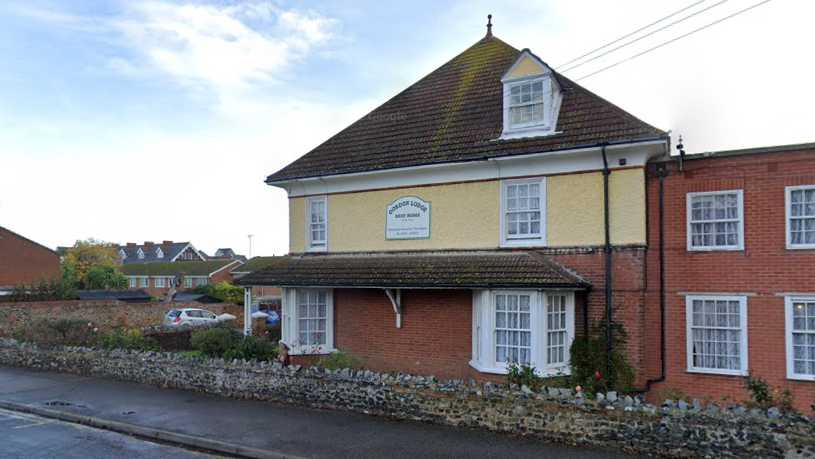 A Google Streetview image of a red and yellow building on a street corner. It is two-storey with a loft conversion.