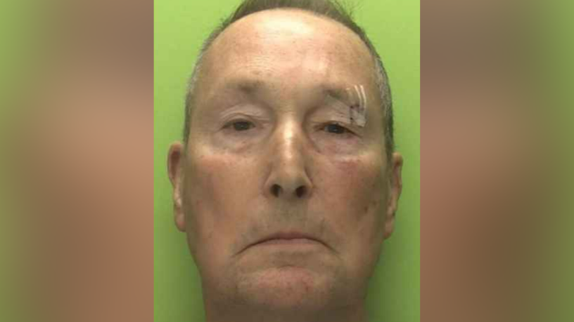 A police image of an offender with a green background. He is white and clean shaven. He has two cuts above his eyebrow, which have been surgically glued.