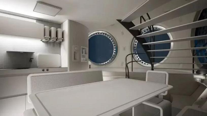 Artist impression of the inside ship with white tables and white kitchen area and stairs in the background.