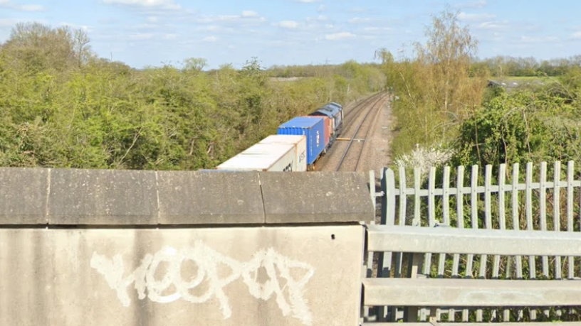 A view of a freight train from a bridge over the rail track 