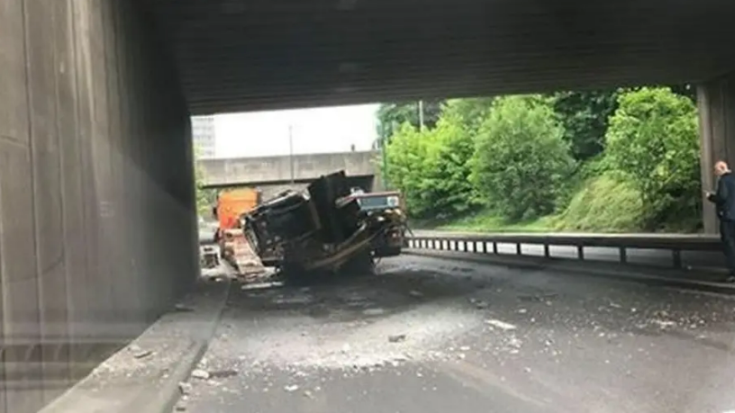 A digger in the road under Nottingham's QMC bridge after it was knocked off a lorry in a crash in 2018.