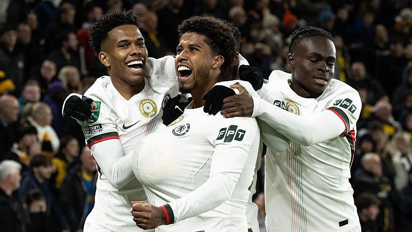 Chelsea attackers Estevao Willian and Tyrique George celebrate the opener against Wolves with goal-scorer Andrey Santos at Molineux Stadium.