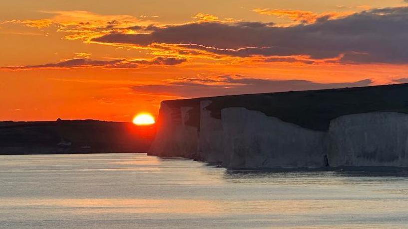 Sunset behind the cliffs of Birling Gap 