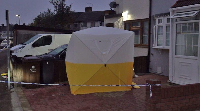 An image of a yellow and white police forensics tent outside a property in First Avenue, Dagenham