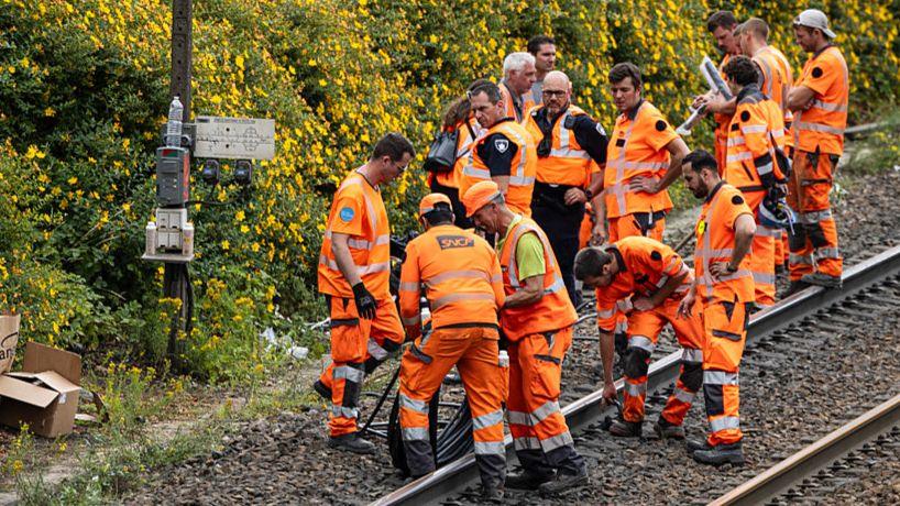 echnicians of French railway company SNCF work to reconnect railway cables at the Mont-de-Terre train station in Lille, northern France on June 25, 2025. 