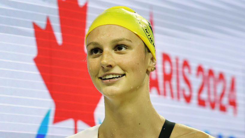 A picture of Canadian swimmer Summer McIntosh wearing a yellow swim cap 