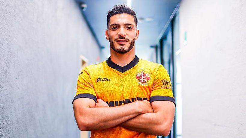 Raul Jimenez poses after re-signing for Wolves