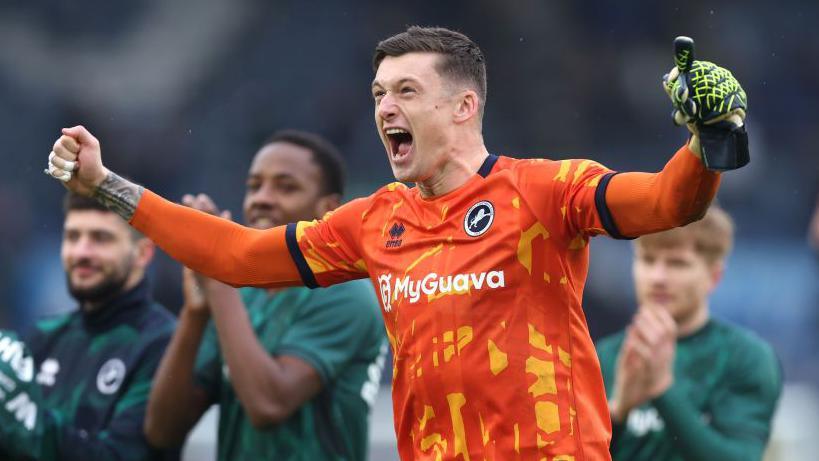 Millwall goalkeeper Liam Roberts celebrates after Millwall knock Leeds United out of the FA Cup