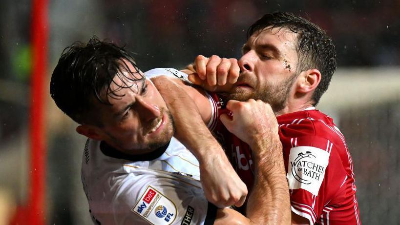 Joe Williams of Bristol City and Ryan Leonard of Millwall clash 
