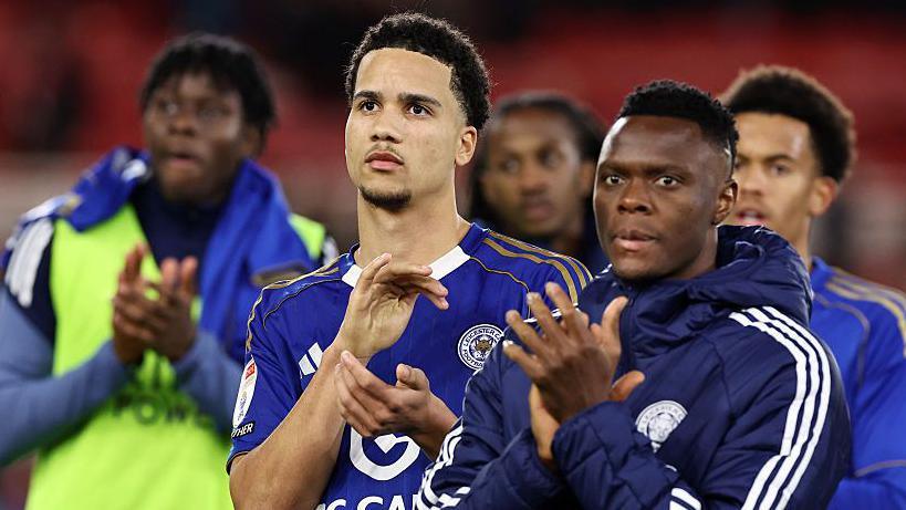 A dejected looking Divine Mukasa and Patson Daka applaud the travelling Leicester City fans