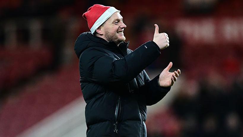 Kim Hellberg gives a thumbs up to the Middlesbrough fans while wearing a Santa hat