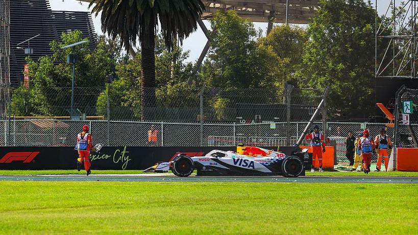 A marshal runs on the track during the Mexico City Grand Prix