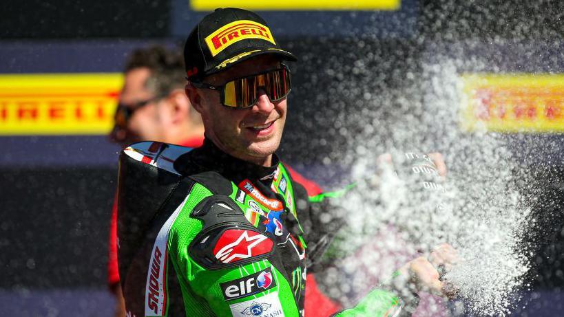 Jonathan Rea sprays champagne after one of his many wins in Kawasaki colours