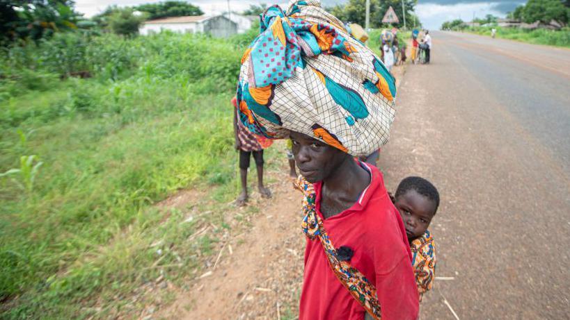 Displaced people from the province of Cabo Delgado walk through the streets of Namapa, Erati district of Nampula, Mozambique on February 27, 2024