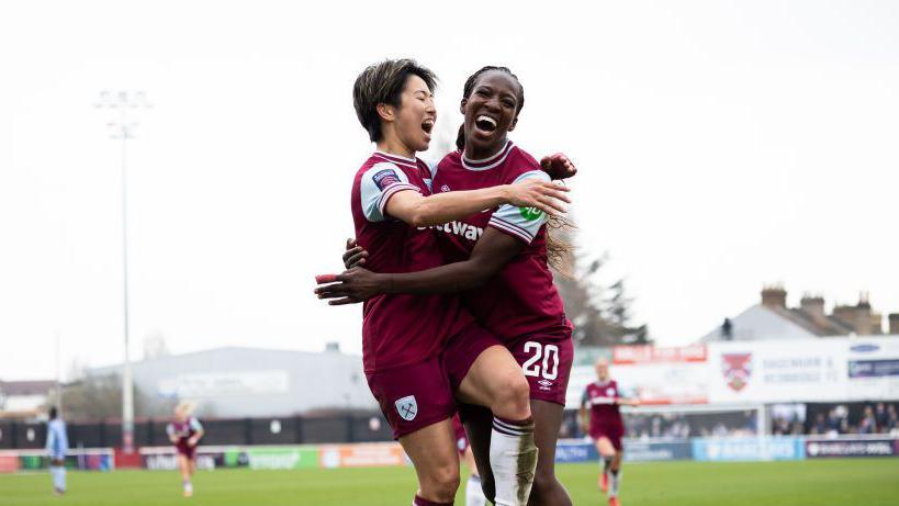 Asseyi and Ueki celebrate the second West Ham goal v Tottenham