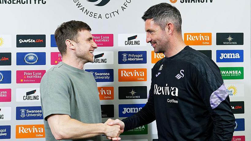 Richard Montague shakes hands with Alan Sheehan