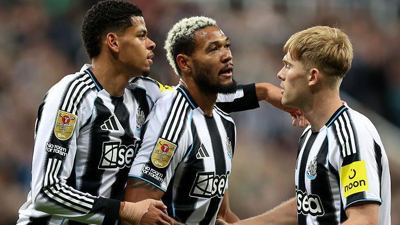 Joelinton celebrates with team-mates William Osula and Lewis Hall after scoring Newcastle United's opening goal