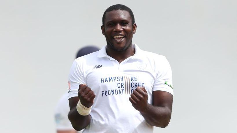 Keith Barker pumps both fists in celebration at taking a wicket
