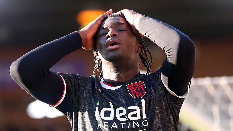 Hindolo Mustapha puts his hands to his head during a match for West Bromwich Albion