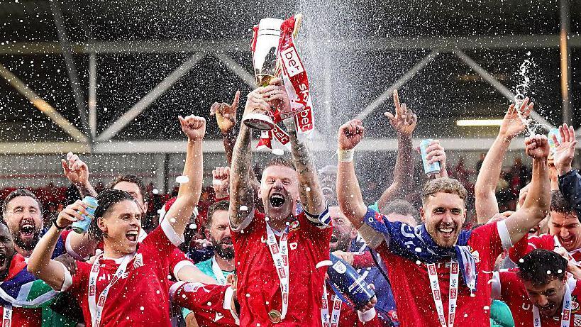 Wrexham players celebrating their promotion last weekend