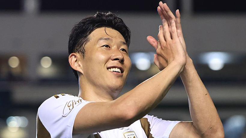 Former Tottenham forward Son Heung-min applauding in a white LAFC shirt