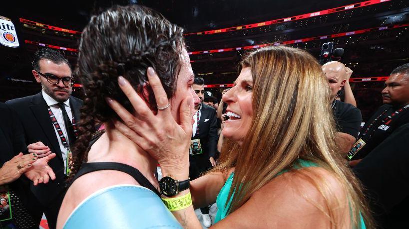 Katie Taylor is congratulated by her mother in the ring