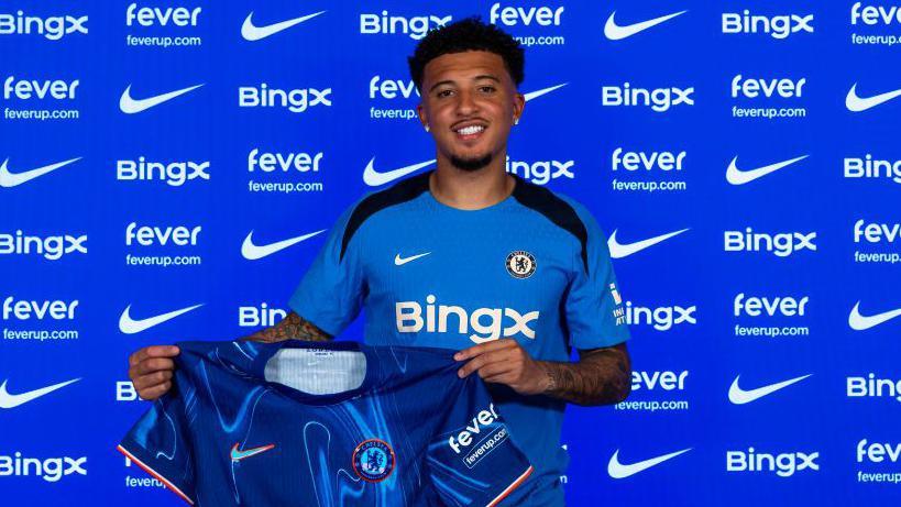 Jadon Sancho with a Chelsea shirt