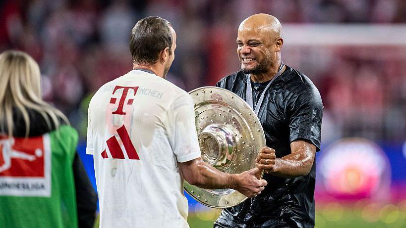 Kane with manager Vincent Kompany