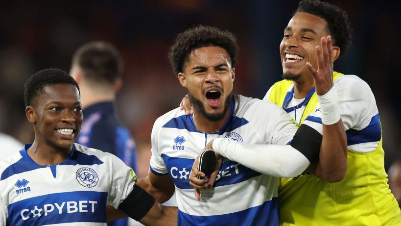 Alfie Lloyd [centre] celebrates QPR's win at Luton Town