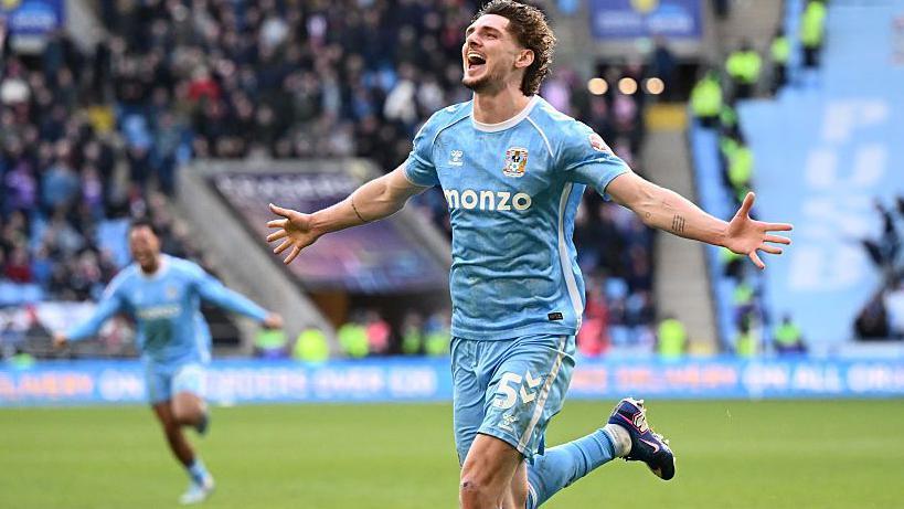 Jack Rudoni outstretches his arms in celebration after scoring against Derby to move them closer to a Premier League return.