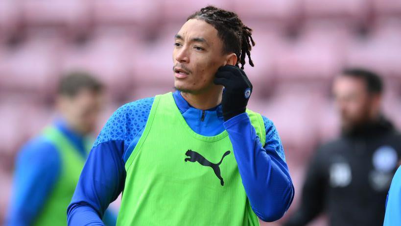 Sean Clare of Wigan Athletic pre-match warm up ahead of the Sky Bet League One match between Wigan Athletic and Stevenage at DW Stadium on January 27, 2024 in Wigan, England.