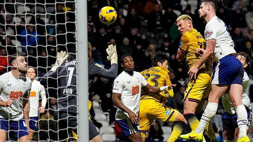 Defender Lewis Miller jumps in the six-yard box to head Blackburn in front against Preston at Deepdale