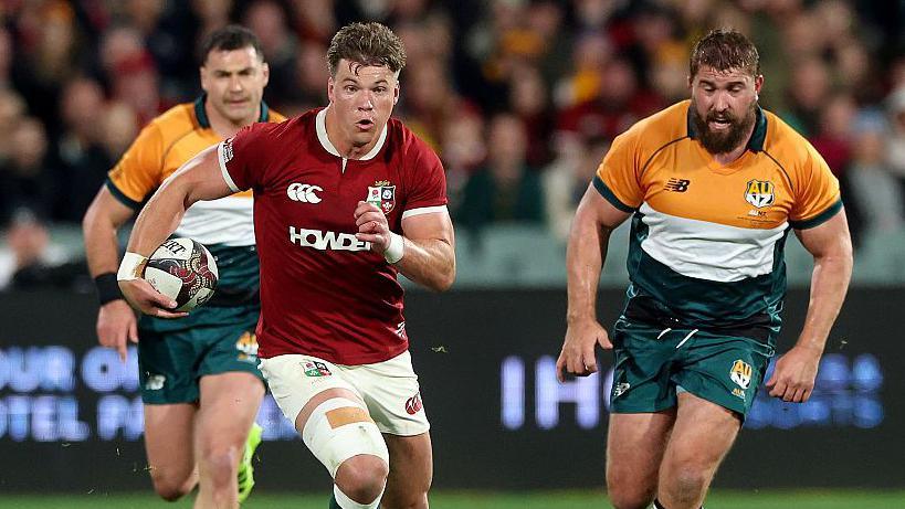 Huw Jones runs with the ball