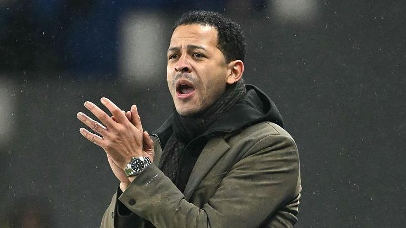 Liam Rosenior clapping on the touchline while managing French club Strasbourg