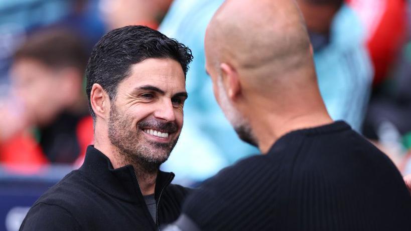 Mikel Arteta and Pep Guardiola anterior  to Manchester City's Premier League gully  astatine  location  to Arsenal