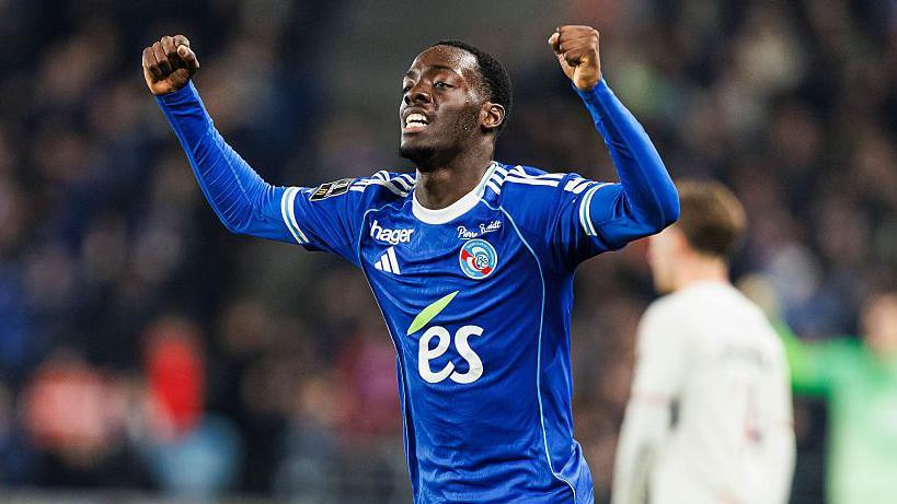 Rabby Nzingoula celebrates while wearing a blue Strasbourg shirt