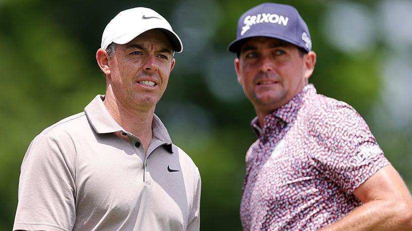 Rory McIlroy of Northern Ireland and Keegan Bradley of the United States on the first tee during the second round of the Travelers Championship 2025 at TPC River Highlands 