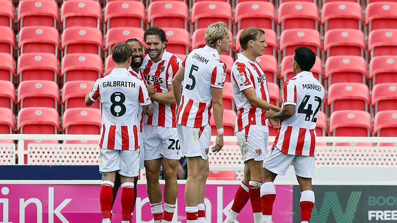 Stoke City players celebrate the opening goal against Oldham