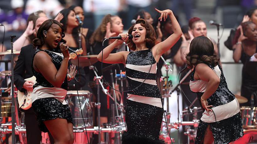 Raye performing a half-time show during an NFL game at Tottenham Hotspur Stadium in October 2025 