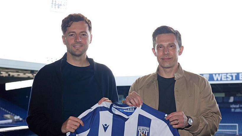 Ryan Mason and Andrew Nestor holding the West Brom shirt