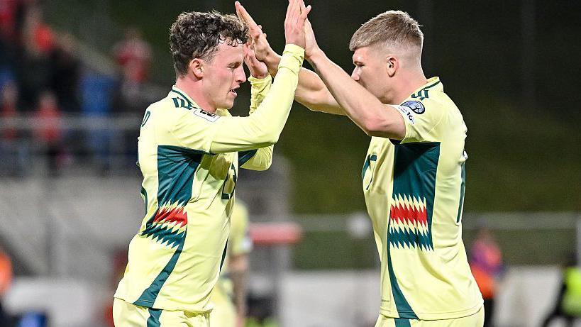 Nathan Broahead and Jordan James of Wales celebrate a goal against Liechtenstein.