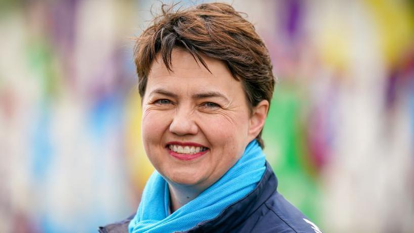 Former Scottish Conservative leader Ruth Davidson, smiling. She is wearing a blue scarf and jacket.