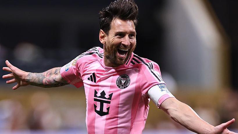 Lionel Messi celebrates in a pink Inter Miami shirt