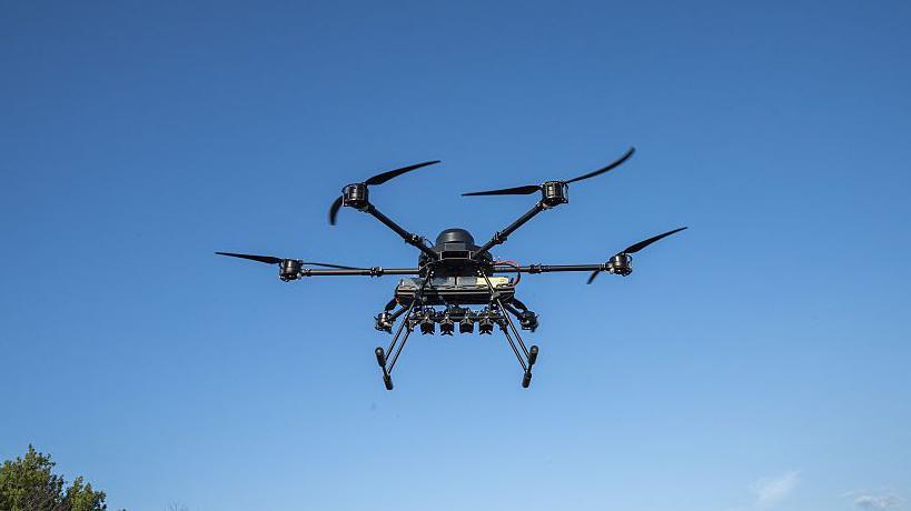A view of a Vampire and Kamikaze BC drone used by the 59th Brigade during tests before deployment to the frontline in Dnipro, Ukraine on May 21, 2025. The drone has four prongs and is flying in a blue sky.