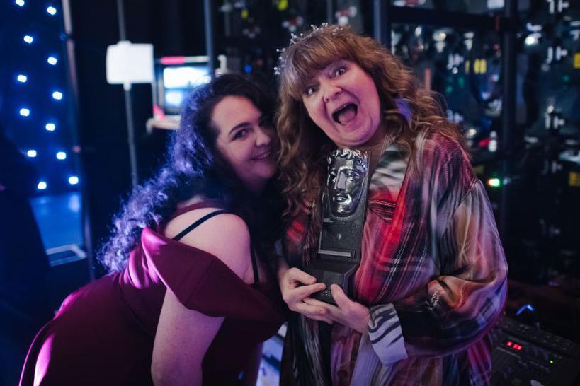 ashley storrie and Janey godley, dressed in tartan and holding an award