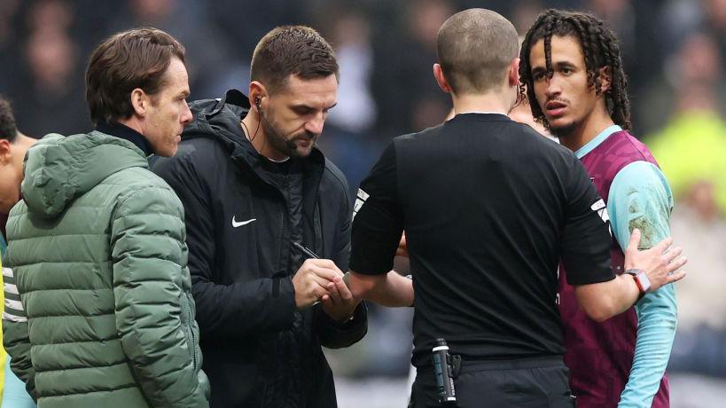 Hannibal Mejbri talks to match referee Andrew Kitchen as fourth official John Busby takes notes and manager Scott Parker looks on